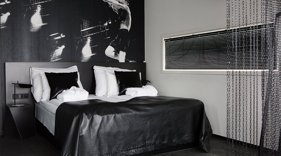 Suite acdc med en dobbel seng med skinnteppe ved Comfort Hotel Union Brygge Drammen
